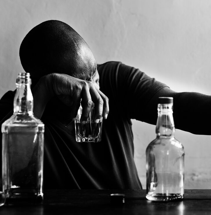 Man drinking alcohol in secret, hiding addiction from his spouse
