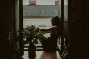 Woman reflecting on unresolved childhood trauma that resurfaces in marriage